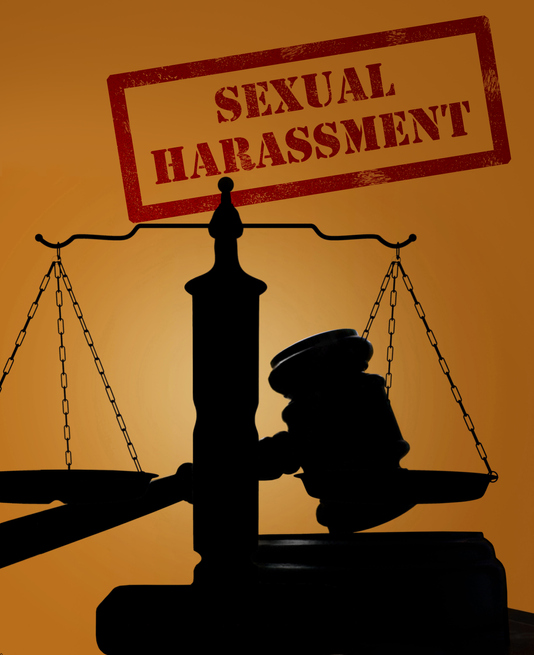 Court gavel and scales of justice silhouette with Sexual Harassment stamp