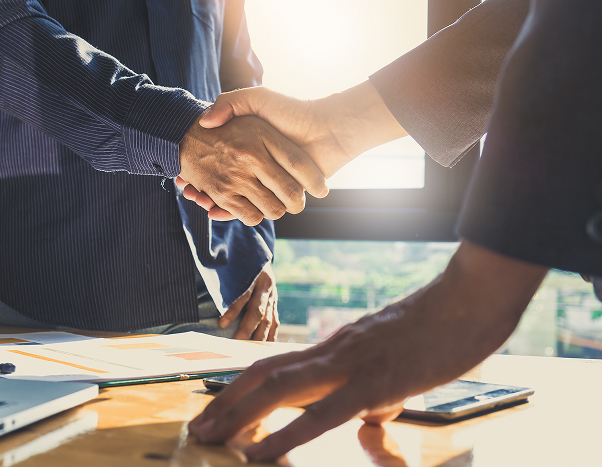 Attorney meeting with a client and shaking hands in a Cincinnati law office.
