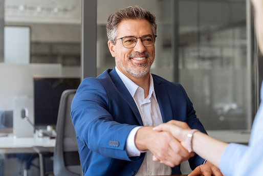 An attorney greeting a client with handshake